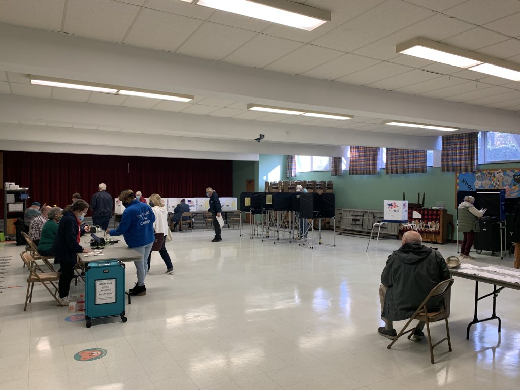 A polling place in a church where people are casting their votes.