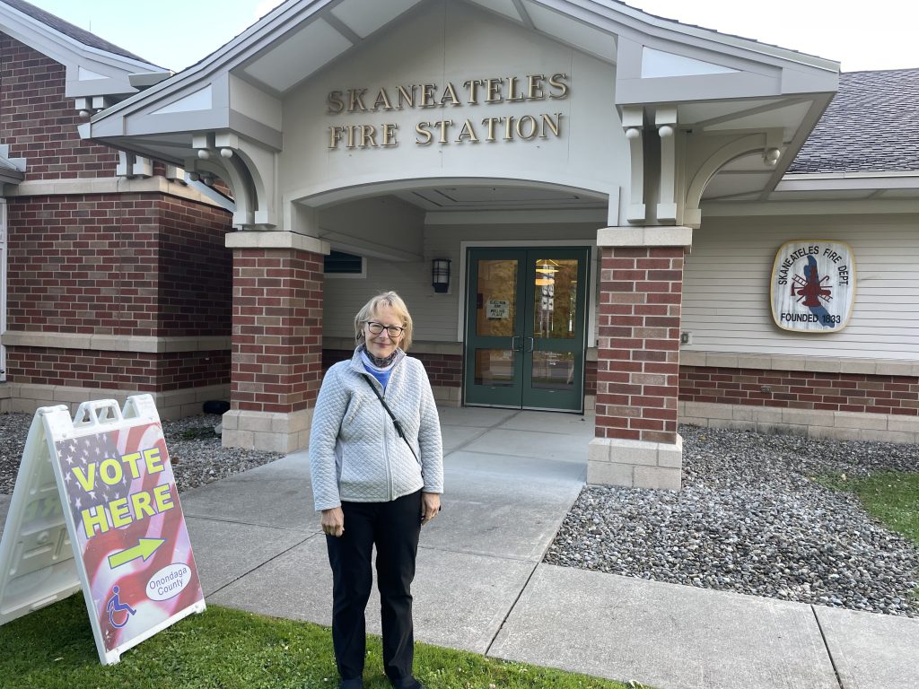 Janet Aaron stands in front of at the polling at the Skaneateles Fire Department.